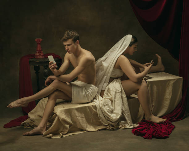 istock Modern remake of classical artwork with modern tech theme - young medieval couple on dark background 1301230480