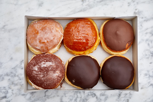 Six Berliner donuts in a box, from above