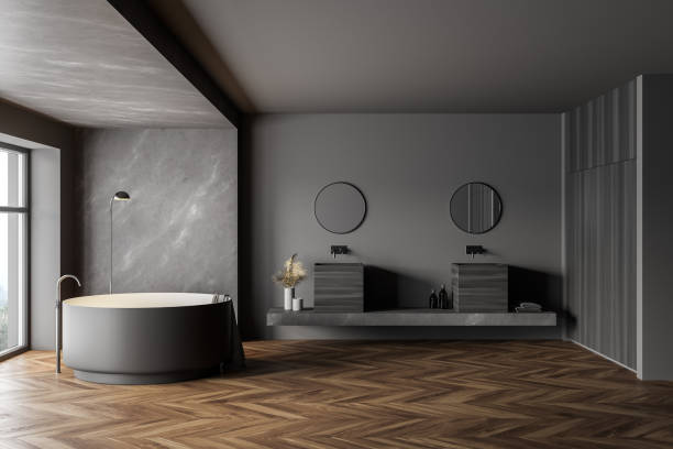 istock Marble and gray bathroom with round tub and two sinks 1301232281