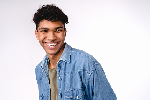 Happy cheerful young mixed-race man laughing isolated over white background