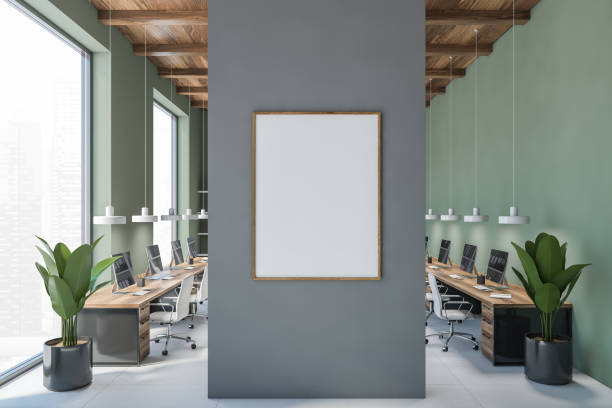istock Blank canvas in green office with computers and white armchairs 1301235191