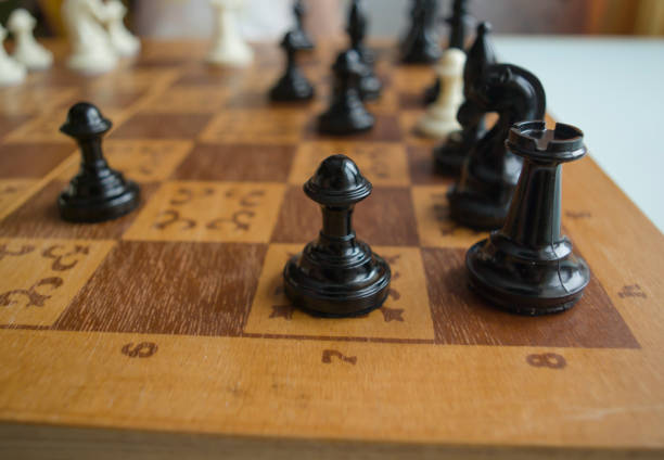 istock Black and white chess pieces were placed on the chessboard during the game 1301236213