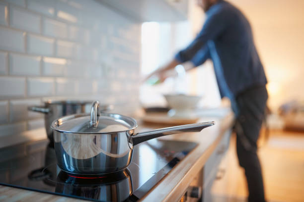 istock A young man at the kitchen. Kitchen, housework, quarantin, home 1301236374