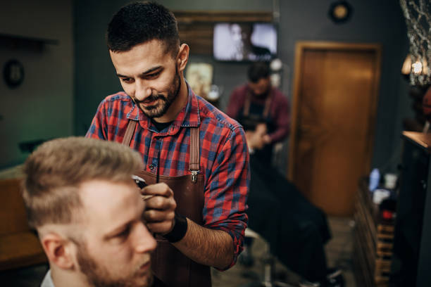 istock Busy day in barber shop 1301236480
