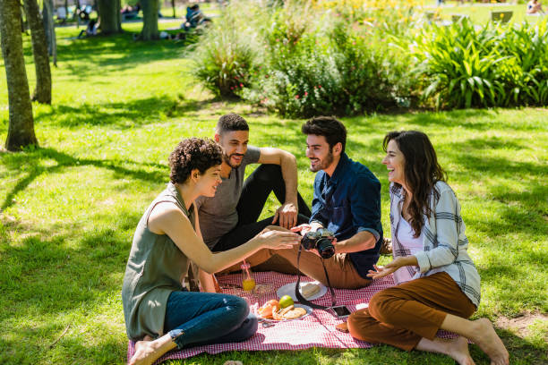 istock Friends looking at photos during picnic 1301237036