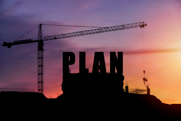 istock Cranes building construction, cooperate for successful work. Silhouette staff works as a team 1301237098