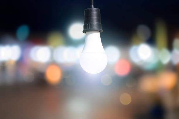istock Light Bulb, world environment day concept. Abstract blur colorful bokeh city lights over 1301237185