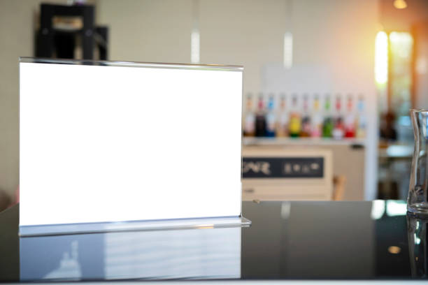 Stand mock up menu frame standing on wood table in bar restaurant cafe. space for text.
