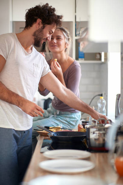 istock A young guy enjoying preparing a meal for his girlfriend. Cooking, home, kitchen, relationship 1301237757