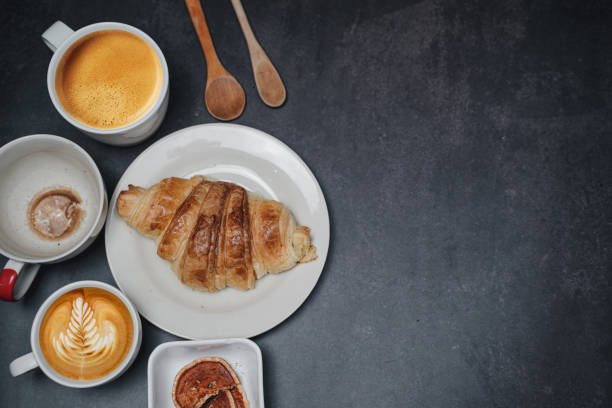 istock cup of coffee and Fresh baked croissant on old kitchen table. Top view with copyspace for your text. 1301237802
