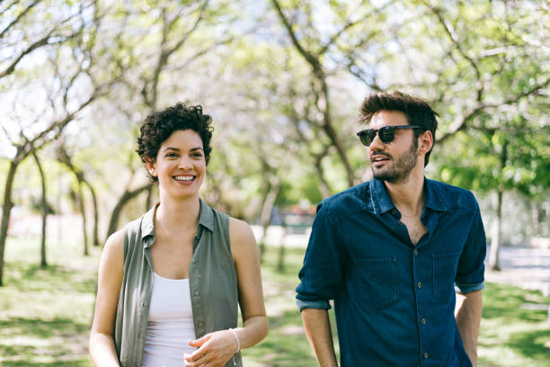 istock Couple strolling in the public park 1301237875
