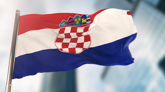 National Flag of Croatia Against Defocused City Buildings