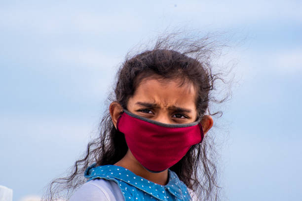 five years old girl wearing mask at home in south India