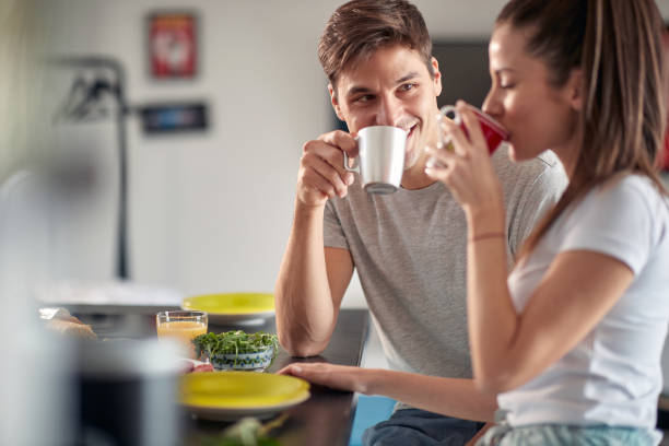 istock A young couple drinking a coffee before breakfast at home. Couple, relationship, breakfast, together 1301239340