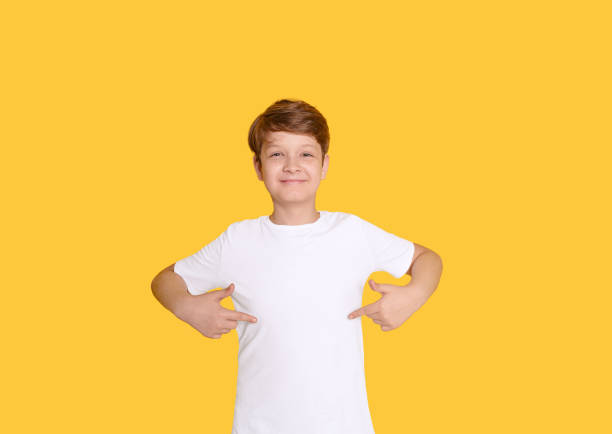 istock Child pointing his fingers on a blank t-shirt 1301239579
