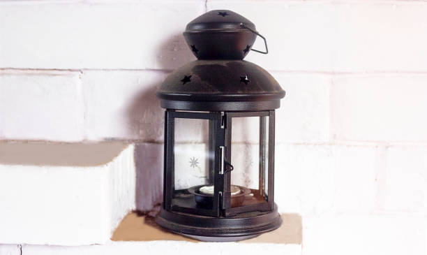 istock A decorative retro lantern stands on a white rustic stove. 1301239820