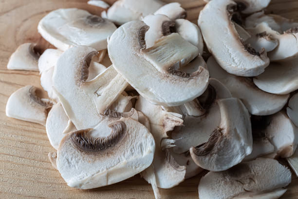 istock Thinly sliced mushrooms. White raw champignons. Top view. Shallow depth of field 1301240213