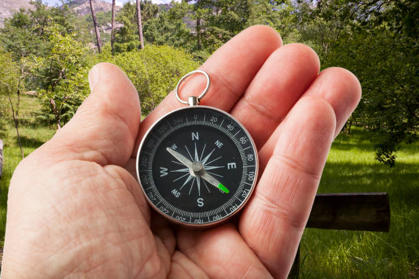 istock Hand with a Compass in the Middle of Nature 1301241387