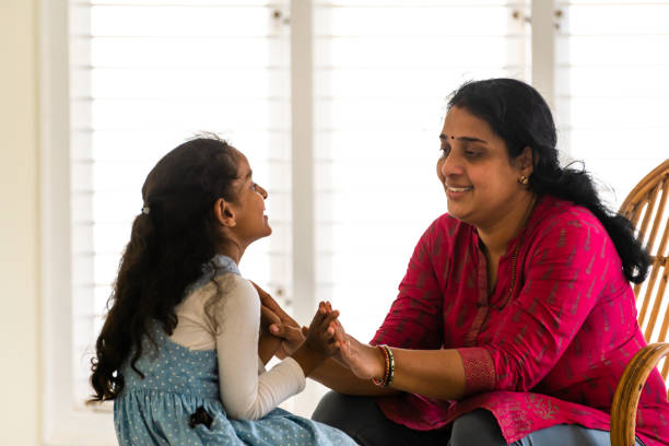 istock mother and daughter playing at home 1301241556
