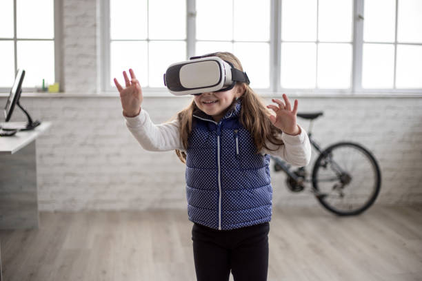 istock Girl playing with virtual reality headset 1301241916