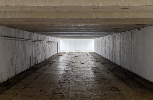 The old underpass is deserted as a symbol of the unknown.