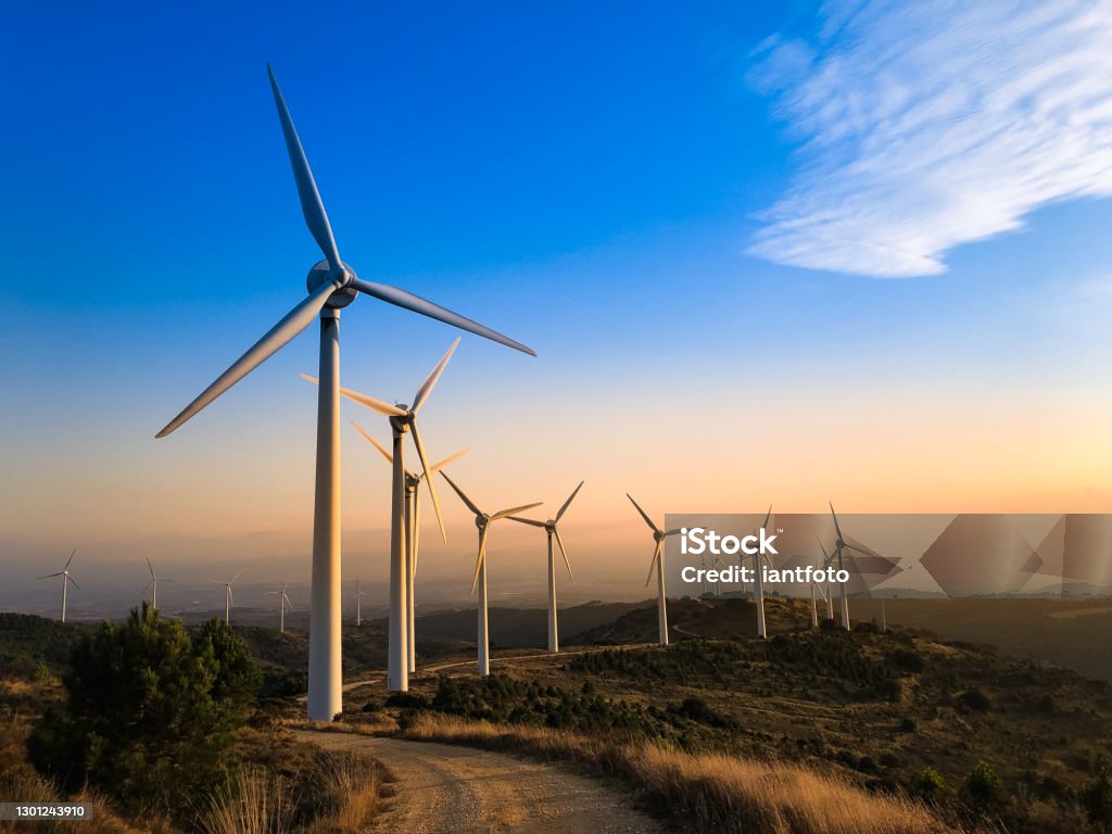 Wind farm at sunset. Wind farm in Navarre, Spain at sunset. Renewable energy concept. Wind Turbine Stock Photo