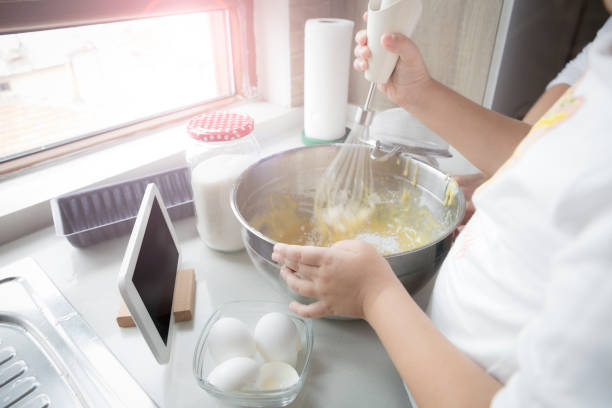 istock Little girl preparing dough for cake in kitchen 1301246918