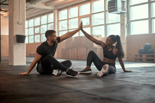 istock Workout partners high-fiving at the gym 1301247414