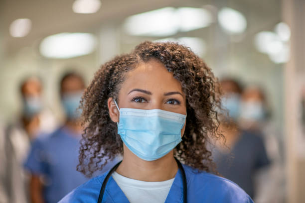 istock Beautiful female doctor smiling behind her mask 1301248821