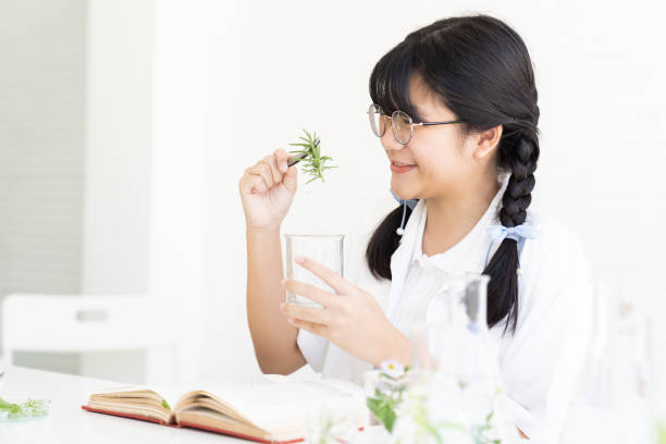 Asian girl scientists learning and doing analysis for germs and bacteria with glassware in the laboratory. Science and education, researcher and discovery concept