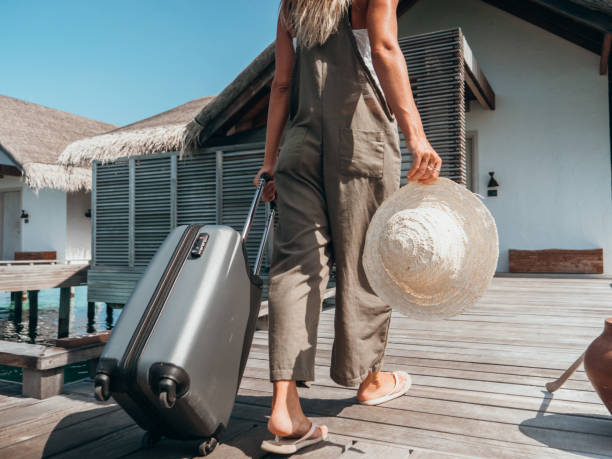istock Woman pulls trolley on wooden pier in tropical destination 1301249021