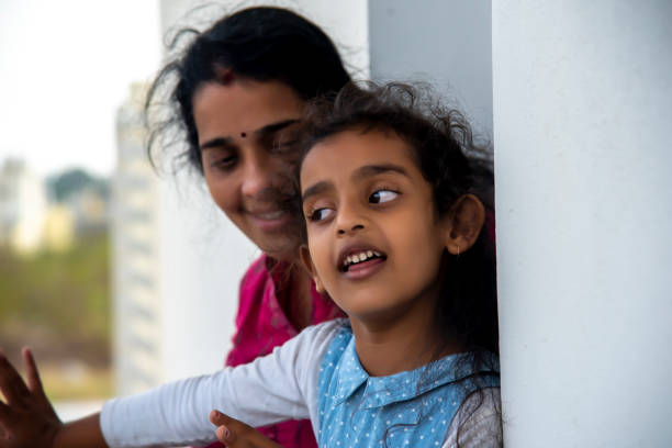 istock mother and daughter playing at home 1301249239