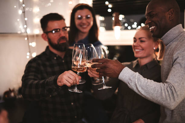istock Smiling friends toasting with drinks during a dinner party 1301249363