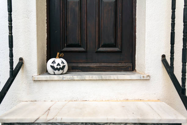 istock Halloween pumpkin at home entrance door 1301250121