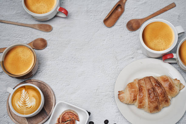 istock cup of coffee and Fresh baked croissant on white kitchen table. Top view with copyspace for your text. 1301250265