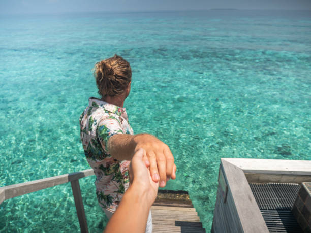 istock Couple holding hands in the Maldives 1301250452