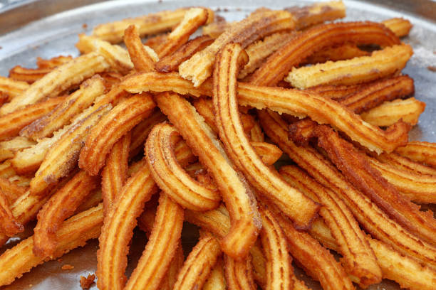 istock Close up sweet fresh churros snack on tray 1301250618