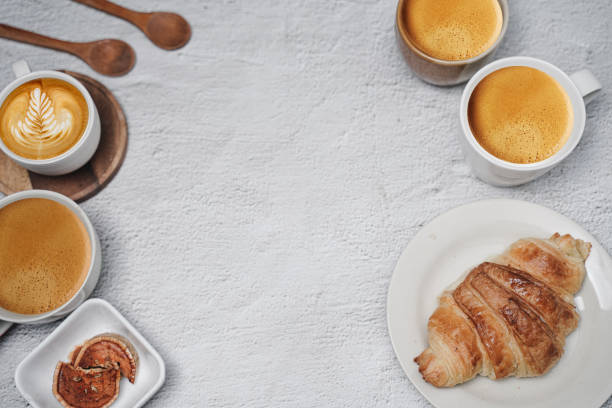 istock cup of coffee and Fresh baked croissant on white kitchen table. Top view with copyspace for your text. 1301250650