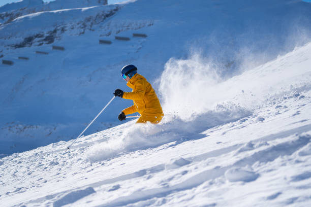 istock powder snow skiing man in sunshine 1301251067