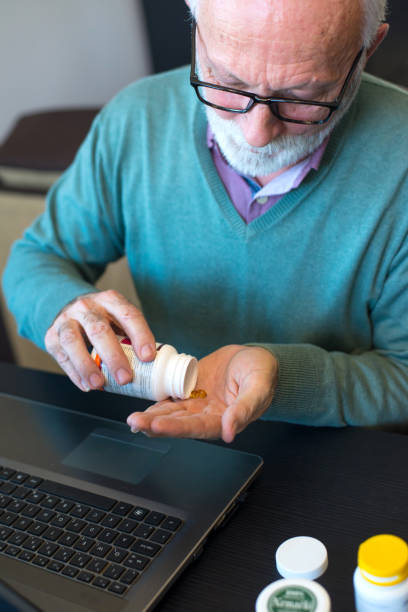 istock Senior man taking his medicine 1301251691