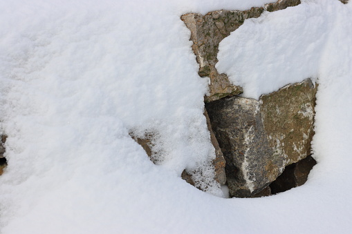 a natural wall is surrounded by snow