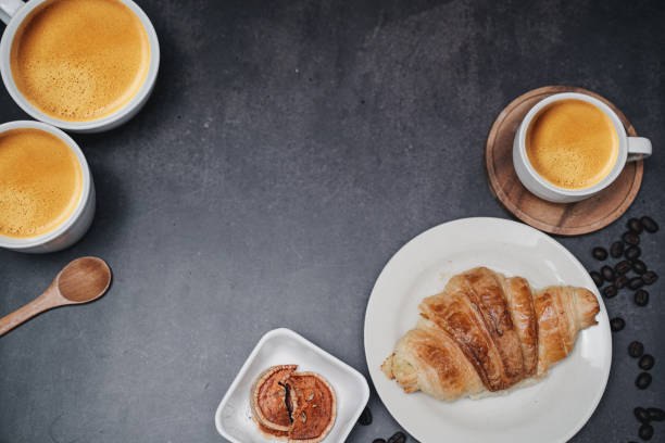 istock cup of coffee and Fresh baked croissant on old kitchen table. Top view with copyspace for your text. 1301252198