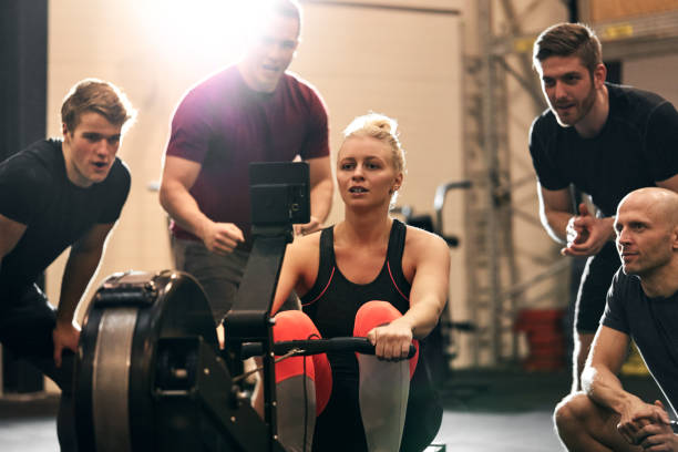 istock Woman surrounded by friends while exercising on  a rowing machine 1301252514