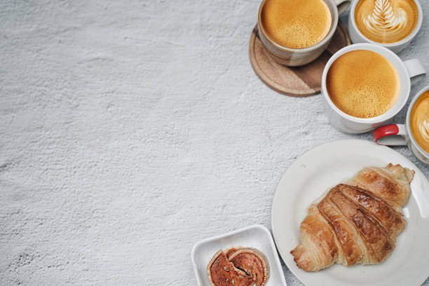 istock cup of coffee and Fresh baked croissant on white kitchen table. Top view with copyspace for your text. 1301253309