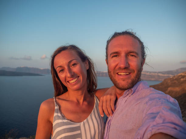 istock Tourists take selfie on coastline at sunset 1301253763