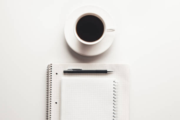 istock Office desk table with supplies, coffee cup and flower. Top view 1301254869