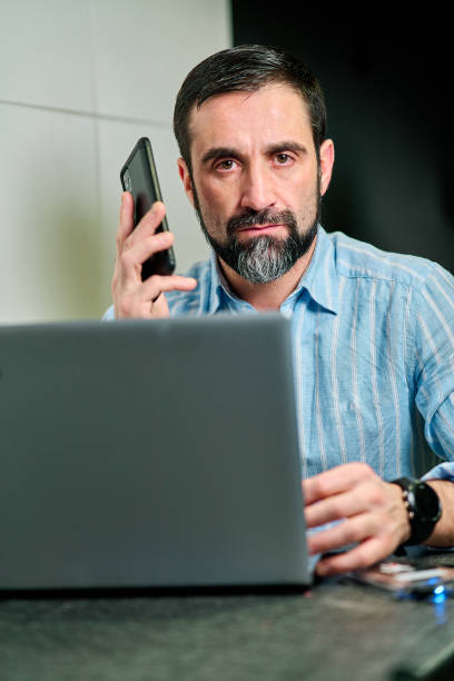 istock white man looking straight ahead while holding the phone to his ear in angry attitude 1301256846