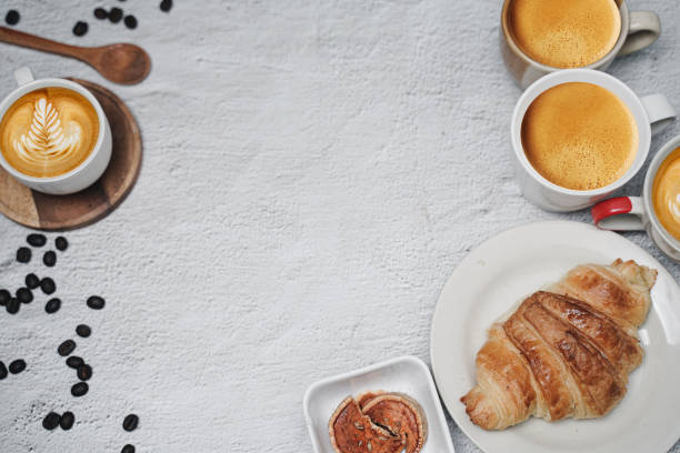 istock cup of coffee and Fresh baked croissant on white kitchen table. Top view with copyspace for your text. 1301257630