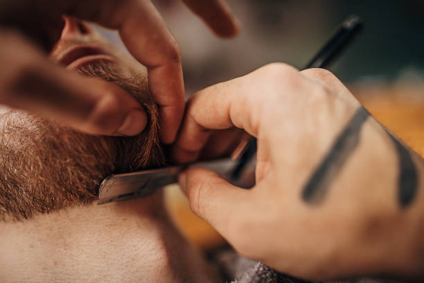 istock Barber shaves the beard of the client 1301257669