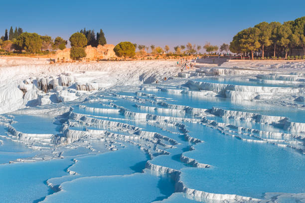 One of the main tourist attractions in Turkey is the travertines and Pamukkale hot springs. Scenic panoramic view on turkish resort One of the main tourist attractions in Turkey is the travertines and Pamukkale hot springs. Scenic panoramic view on turkish resort travertine pool photos stock pictures, royalty-free photos & images